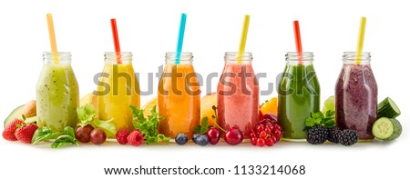 Row of healthy fresh fruit and vegetable smoothies with assorted ingredients served in glass bottles with straws isolated on white in a panorama banner