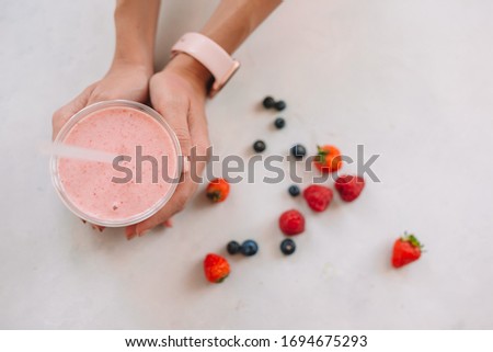 Similar – Mann hält einen Milchshake aus Beeren und Haferflocken.