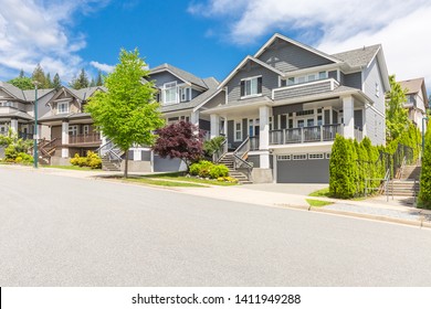 Row of houses or town homes in the suburbs of Canada on a sunny day. Nice neighbourhood, family homes. - Shutterstock ID 1411949288