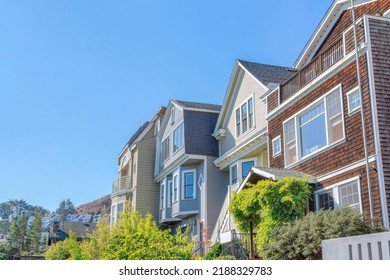 Row Of Houses With Traditional Wood Sidings Against The Clear Sky In San Francisco, California. There Is A House At The Front With Wood Shingle Sidings Along With The Houses With Wood Planks Siding.