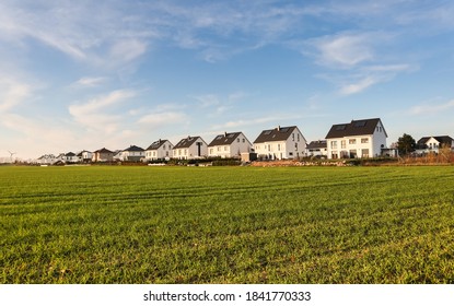 Row Of Houses In A Village By An Autumnal Field - Sunny, Blue Sky