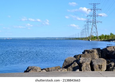 Row Of Hydro Towers Along Shore Of Lake Ontario During Spring