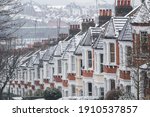 Row of identical English terraced houses covered by snow in Crouch End, London