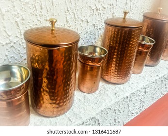 A Row of Indian Copper Coffee Pots and Cups