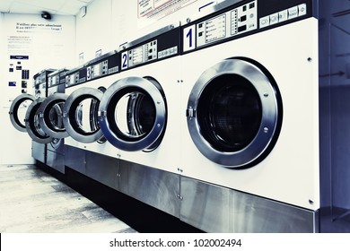 Row Of Industrial Washing Machines In A Public Laundromat