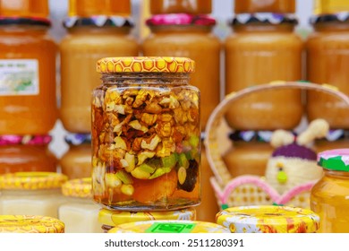 A row of jars filled with various types of food, walnuts in honey