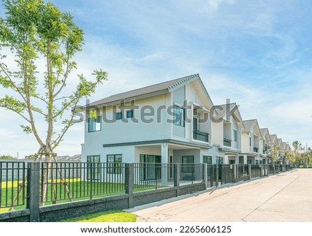 The row of Just finished modern houses with blue sky backgrounds and copy space, the architectural design of the exterior, The concept for Sale, Rent, Housing, and Real Estate.