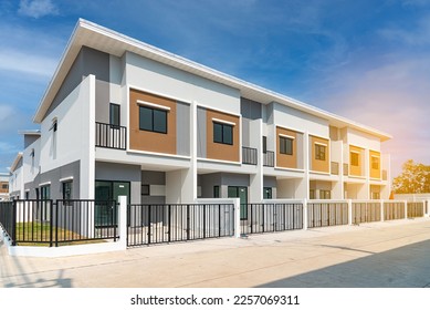 The row of just finished new townhouses, the Concept of buying a house vs renting an apartment,  architectural design exterior townhomes  with blue sky. - Shutterstock ID 2257069311