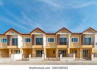 The row of just finished new yellow townhouses, Front View of New Residential house, the architectural design of the exterior with blue sky and apace,The concept for Sale, Rent,Housing,and Real Estate - Shutterstock ID 2261106165