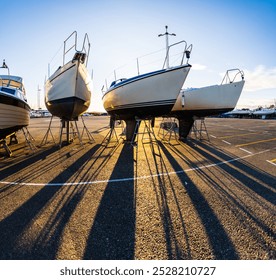 Row of laid up motor boats and sailboats at a marina - Powered by Shutterstock