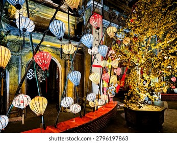 A row of lanterns hang from the ceiling. The lanterns are of different colors and sizes
