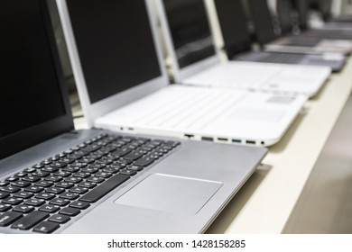 A Row Of Laptops In Computer Shop. Closeup, Selective Focus