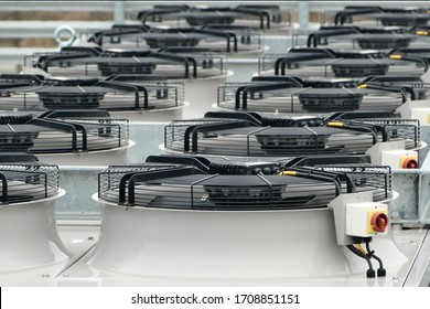 Row of large industrial fans on condenser of ammonia NH3 or Co2 refrigeration system used for cooling chillers and freezers - Shutterstock ID 1708851151