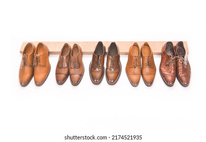 Row Of Leather Mens Shoes. Shelf With Brown Mens Shoes.

