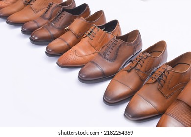 Row Of Leather Mens Shoes. Shelf With Brown Mens Shoes.

