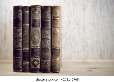 Row Of Leather Vintage Books On Shelf