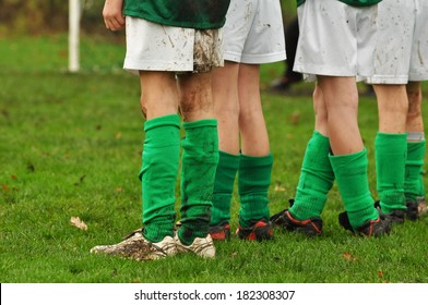 Row Legs Of Soccer Playing Kids Waiting For A Penalty