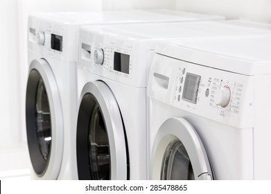 Row Line Of Modern White Laundry Washing Machines