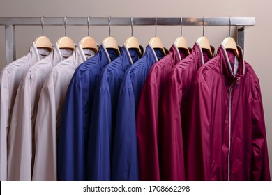 Row Of Many Different Colorful Hoodie Jackets, Sport Jackets For Men And Women. Colorful Background Of Modern Spring, Autumn Outerwear. New Collection. Seasonal Clothing In Store On Sale.