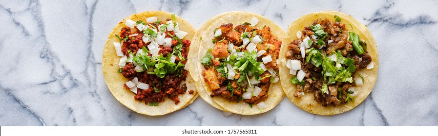 row of mexican street tacos with carne asada and al pastor in corn tortilla wide banner composition - Shutterstock ID 1757565311