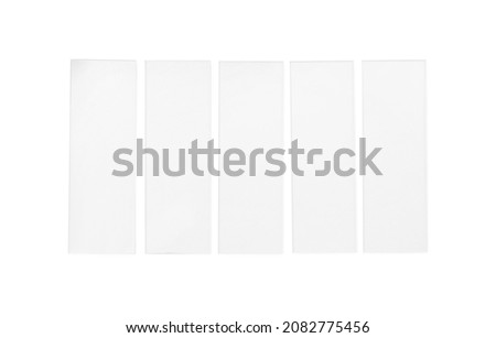 Row of microscope slides on white background, top view