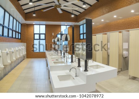 Row of modern white ceramic wash basin in public toilet or restaurant or hotel or shopping mall, interior design