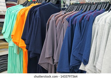 Row of Multi-color Men's T-shirts on Cloth Hangers in the Store - Shutterstock ID 1433797364