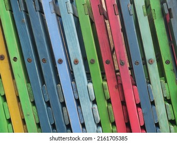 a row of multicolored wooden chairs near a terrace in Amsterdam