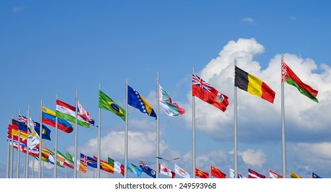 Row of national flags against blue sky