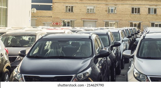 A Row Of New Cars Parked At A Car Dealer Shop