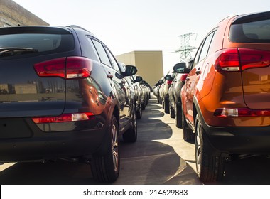 A Row Of New Cars Parked At A Car Dealer Shop