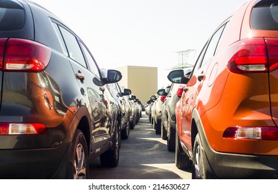 A Row Of New Cars Parked At A Car Dealer Shop