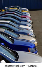 A Row Of New Cars Parked At A Car Dealer Shop