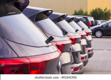 A Row Of New Cars Parked At A Car Dealer Shop