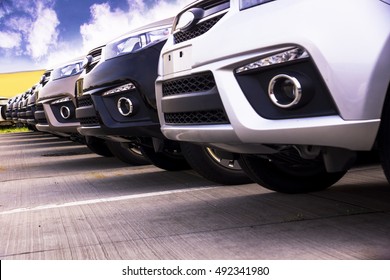 A Row Of New Cars Parked At A Car Dealer Shop