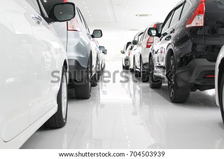 A row of new cars parked at a car dealership stock, New Japanese cars in showroom for show customers.