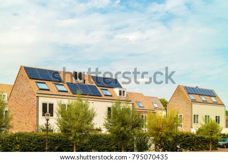 Row of new Dutch houses with solar panels in Amsterdam