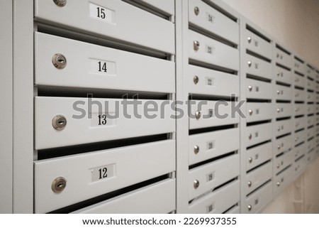 A row of new empty mailboxes with numbers of apartments