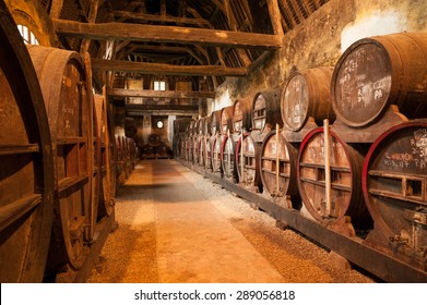 Row of oak barrels in Calvados distillery, Normandy, France