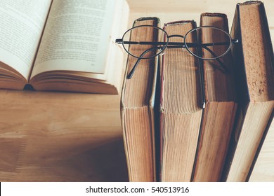 Row Of Old Books With Reading Glasses Above , Vintage Color Tone