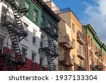 Row of Old Brick Buildings in Little Italy of New York City with Fire Escapes