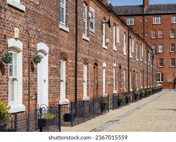 row of old brick built terraced house in the north of England with iron railings , afternoon on a sunny day no body around - Shutterstock ID 2367015559