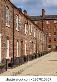 row of old brick built terraced house in the north of England with iron railings, afternoon on a sunny day nobody around - Shutterstock ID 2367015669