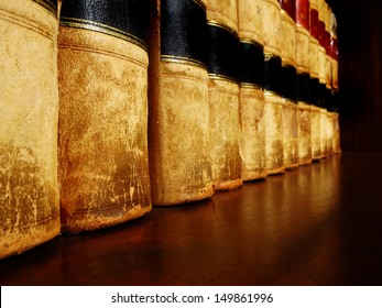 Row of old leather books on a shelf