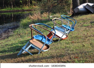 A Row Of Old Metal Lawn Chairs