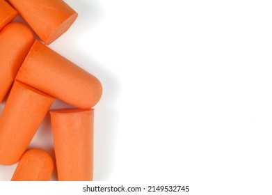 A Row Of Orange Earplugs On A White Background. Close-up.Soft Foam Earplug