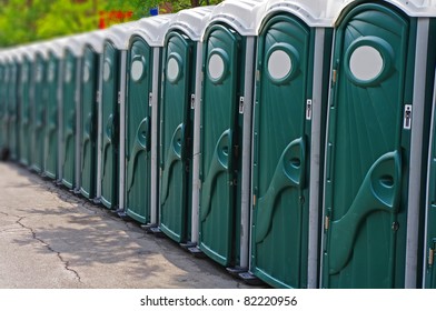 Row of outhouses or porta potties waiting to be used