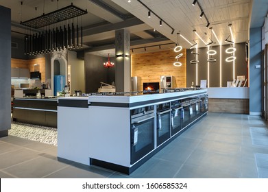 Row Of Ovens An Gas Stoves Selling In Appliance Retail Store Showroom, Other Home Appliance At Background