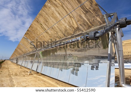 A row of parabolic trough solar mirror panels harnessing the sun's rays to provide renewable alternative green energy