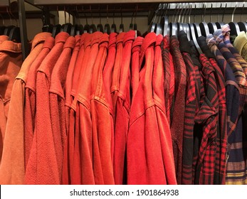 Row Of Plaid ,shirts Sorted In Color Order On Hangers On A Shop Wardrobe Closet Rail

